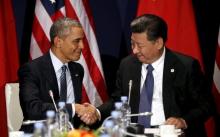 U.S. President Barack Obama shakes hands with Chinese President Xi Jinping during their meeting at the start of the climate summit in Paris, November 30, 2015. PHOTO BY REUTERS/Kevin Lamarque