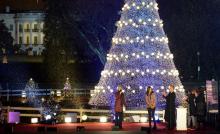 U.S. President Barack Obama (3rd L) applauds with the First Family as host Jane Lynch (L) speaks after Obama threw the switch at the conclusion of the National Christmas Tree Lighting ceremony on the Ellipse in Washington, D.C.