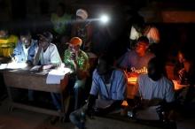 Electoral observers listen to and write vote counts at the end of the presidential and legislative elections, in the mostly muslim PK5 neighbourhood of Bangui, Central African Republic, February 14, 2016. PHOTO BY REUTERS/Siegfried Modola