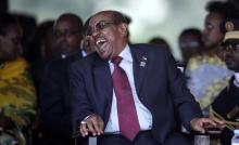 Sudan's President Omar Hassan al-Bashir laughs during the swearing-in ceremony of Uganda's president, Yoweri Kaguta Museveni at the Kololo independence grounds in Kampala, Uganda, May 12, 2016. PHOTO BY REUTERS/Edward Echwalu