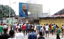 Congolese opposition supporters chant slogans as they destroy the billboard of President Joseph Kabila during a march to press the President to step down in the Democratic Republic of Congo's capital Kinshasa, September 19, 2016. PHOTO BY REUTERS/Kenny Katombe