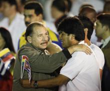 Nicaragua's President Daniel Ortega (L) hugs his Bolivian counterpart Evo Morales before the march of the torches in celebration of the 161th birth anniversary of Cuba's independence hero Jose Marti in Havana