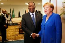 Acting German Chancellor Angela Merkel shakes hand with Ivory Coast's President Alassane Ouattara ahead of the 5th African Union - European Union (AU-EU) summit in Abidjan, Ivory Coast, November 29, 2017. PHOTO BY REUTERS/Luc Gnago