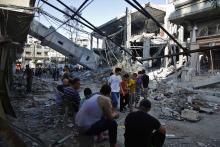 Palestinians gather near the minaret of a mosque that police said was destroyed by an Israeli Air strike in Gaza City