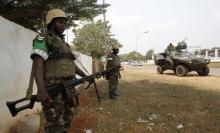 Members of the African peacekeeping forces stand in a street in Bangui, February 19, 2014. PHOTO BY REUTERS/Luc Gnago