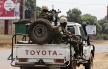 Members of the African peacekeeping forces ride at the back of a pickup in a street in Bangui, February 19, 2014. PHOTO BY REUTERS/Luc Gnago