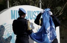 Senegalese officers with the FPU (Formed Police Units) unfold a United Nations flag during the opening ceremony of the United Nations Mission for Justice support in Haiti (MINUJUSTH) in Port-au-Prince, Haiti, October 16, 2017. PHOTO BY REUTERS/Andres Martinez Casares