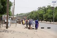 People walk along a road as they flee, in Maiduguri in Borno State, Nigeria, May 14, 2015. PHOTO BY REUTERS/Stringer