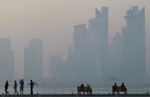 People sit on the corniche in Doha, Qatar, June 15, 2017. PHOTO BY REUTERS/Naseem Zeitoon