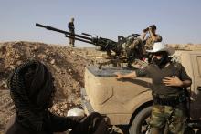 Kurdish Peshmerga fighters guard their position on the Jalawla front line in the northeastern district of Baquba near the city of Khanaqin