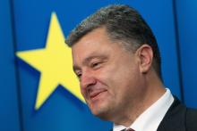 Ukraine's President Petro Poroshenko smiles as he speaks during a news conference at the EU Council in Brussels