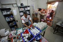 Pharmacists prepare medicine for two HIV-positive patients at Medecins Sans Frontieres-Holland (AZG)'s clinic in Yangon