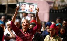 A woman carries a photograph as she mourns her family members suspected to be missing following a landslide when a mound of trash collapsed on an informal settlement at the Koshe garbage dump in Ethiopia's capital Addis Ababa, March 14, 2017. PHOTO BY REUTERS/Tiksa Negeri