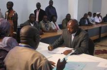 Burundian President Pierre Nkurunziza (seated, C) registers to run for a third five-year term in office, in the capital Bujumbura, May 8, 2015. PHOTO BY REUTERS/Jean Pierre Aime Harerimana