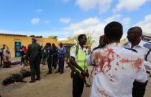 A Somali traffic policeman talks to his phone after he was wounded during a suicide car bomb explosion outside the traffic police headquarters in Somalia's capital Mogadishu, May 9, 2016. PHOTO BY REUTERS/Feisal Omar