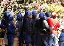 Police officers clash with demonstrators during a protest by opposition party supporters in Harare, Zimbabwe, August 26,2016. PHOTO BY REUTERS/Philimon Bulawayo