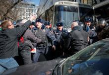 Law enforcement officers scuffles with opposition supporters blocking a van transporting detained anti-corruption campaigner and opposition figure Alexei Navalny during a rally in Moscow. PHOTO BY REUTERS/Maxim Shemetov