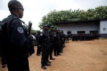 Police officers carry their weapons as they stand on the premises of the National Police Academy in the Cocody neighborhood in Abidjan, Ivory Coast, July 20, 2017. PHOTO BY REUTERS/Luc Gnago