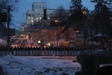 Interior Ministry members stand guard at the site of clashes with anti-government protesters in Kiev