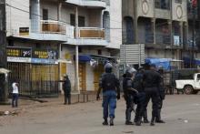 Guinea's security forces patrol on a street in Bambeto during a protest after opposition candidates called on Monday for the results of the election to be scrapped due to fraud, in Conakry, October 13, 2015. PHOTO BY REUTERS/Luc Gnago