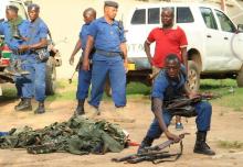 Burundian police officers collect a cache of weapons recovered from suspected fighters after clashes in the capital Bujumbura, Burundi, December 12, 2015. PHOTO BY REUTERS/Jean Pierre Aime Harerimana