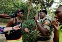 Uganda police officers question a member of Uganda's LGBT community during their pride parade in Entebbe near capital Kampala, before police asked LGBT members to abandon their gathering, September 24, 2016. PHOTO BY RETERS/James Akena