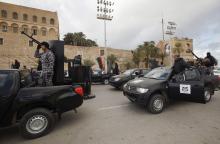 Members of the Libyan Police are seen on their vehicles as the Police prepare for deployment during the start of a security plan put forth by the Tripoli-based government to increase security in the Libyan capital, at Martyrs' Square in Tripoli, February 9, 2015. PHOTO BY REUTERS/Ismail Zitouny