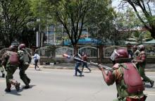 A riot policeman fires tear gas to disperse supporters of Kenyan opposition National Super Alliance (NASA) coalition, during a protest along a street in Nairobi, Kenya, October 16, 2017. PHOTO BY REUTERS/Thomas Mukoya