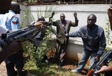 Policemen search a man for weapons as he walked out of Westgate Shopping Centre in Nairobi