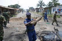 Policemen and soldiers clear a barricade during a protest against President Pierre Nkurunziza and his bid for a third term in Bujumbura, Burundi, May 25, 2015. PHOTO BY REUTERS/Goran Tomasevic