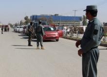 Afghan policemen inspect vehicles at a checkpoint in Helmand province, Afghanistan, February 28, 2017. PHOTO BY REUTERS/Abdul Malik