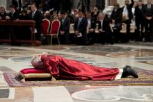 Pope Francis lies on the floor during the Good Friday Passion of the Lord Mass in Saint Peter's Basilica at the Vatican, March 30, 2018. PHOTO BY REUTERS/Osservatore Romano