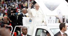 Pope Francis (C) waves to the faithful as he arrives for a meeting with the Kenyan youth at the Kasarani stadium in Kenya's capital Nairobi, November 27, 2015. With him is Cardinal John Njue. PHOTO BY REUTERS/Thomas Mukoya