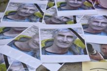 Portraits of mountain guide Frenchman Herve Gourdelin are seen as people pay tribute in Saint-Martin-Vesubie, September 25, 2014. PHOTO BY REUTERS/Patrice Masante