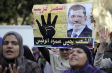 Supporters of Muslim Brotherhood and ousted Egyptian President Mohamed Mursi shout slogans against the military and the interior ministry as they gesture with the sign "Rabaa", or "Four", during a protest around Ain Shams square in east Cairo