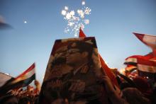 Egyptians chant slogans in Tahrir square as they arrive to celebrate former Egyptian army chief Abdel Fattah al-Sisi's victory in the presidential vote in Cairo