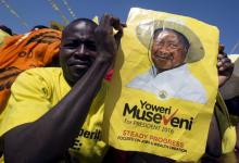 A supporter of Uganda's President Yoweri Museveni holds his campaign poster at a rally in Kololo grounds in capital Kampala, February 16th, 2016. PHOTO BY REUTERS/Edward Echwalu