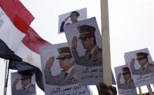 Posters of Army Chief General Abdel Fattah al-Sisi are seen as supporters of the army protest against ousted Islamist President Mohamed Mursi and members of the Muslim Brotherhood