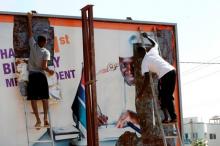 People tear a poster of former Gambian president Yaya Jammeh in Broussbi, Gambia, December 4, 2016. PHOTO BY REUTERS/Thierry Gouegnon