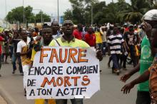 A man holds up a sign, which reads: "Faure still how many death by you", during an opposition protest calling for the immediate resignation of President Faure Gnassingbe in Lome, Togo, September 6, 2017. PHOTO BY REUTERS/Noel Kokou Tadegnon