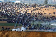 Israeli soldiers shoot tear gas from the Israeli side of the Israel-Gaza border, as Palestinians protest on the Gaza side of the border, March 30, 2018. PHOTO BY REUTERS/Amir Cohen