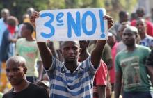 A protester holds a placard as they demonstrate against the ruling CNDD-FDD party's decision to allow Burundian President Pierre Nkurunziza to run for a third five-year term in office, in Bujumbura, May 4, 2015. PHOTO BY REUTERS/Jean Pierre Aime Harerimana