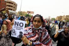 A Sudanese woman holds a placard during a demonstration demanding the ruling military hand over to civilians in Khartoum, Sudan, June 30, 2019. PHOTO BY REUTERS/Umit Bektas