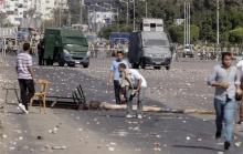 Protesters block a road during clashes with riot police in front of Al-Azhar University in Cairo