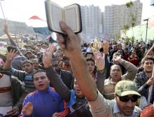 People shout slogans against the military and interior ministry as others hold up copies of the Koran during an Islamist protest in the Cairo suburb of Matariya, November 28, 2014. PHOTO BY REUTERS/Mohamed Abd El Ghany