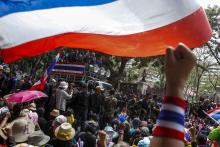 Anti-government protesters gather outside the Royal Thai Police headquarters as anti-government protest leader Suthep Thaugsuban (C, on vehicle) speaks during a rally in central Bangkok