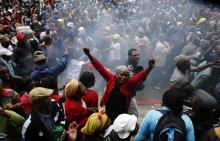 Protestors burn cardboard and refuse as they demonstrate against a lack of housing and other services outside provincial government buildings