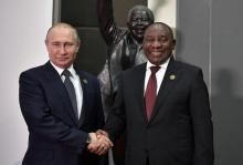 Russia's President Vladimir Putin (L) shakes hands with South Africa's President Cyril Ramaphosa at the BRICS summit in Johannesburg, South Africa, July 26, 2018. PHOTO BY REUTERS/Sputnik/Alexei Nikolsky/Kremlin 