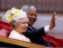 South African President Nelson Mandela is accompanied by Britain's Queen Elizabeth II in a carriage ride to a Buckingham Palace lunch on the first day of his state visit to Britain July 9