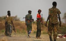 Rebel fighters return from a frontline in a rebel-controlled territory in Jonglei State